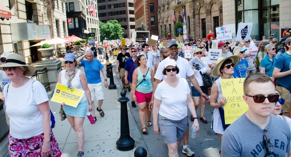 Demonstrators march toward Boston Common to protest U.S. immigration policies. (Elizabeth Gillis/WBUR)
