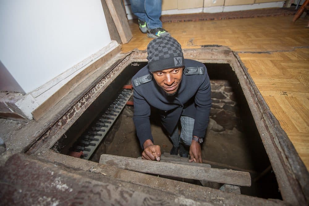 Ray Allen emerges from the basement hiding place where a Polish family hid Jews. All but one of the Polish family were executed by the Nazis. (Photo by Elan Kawesch)