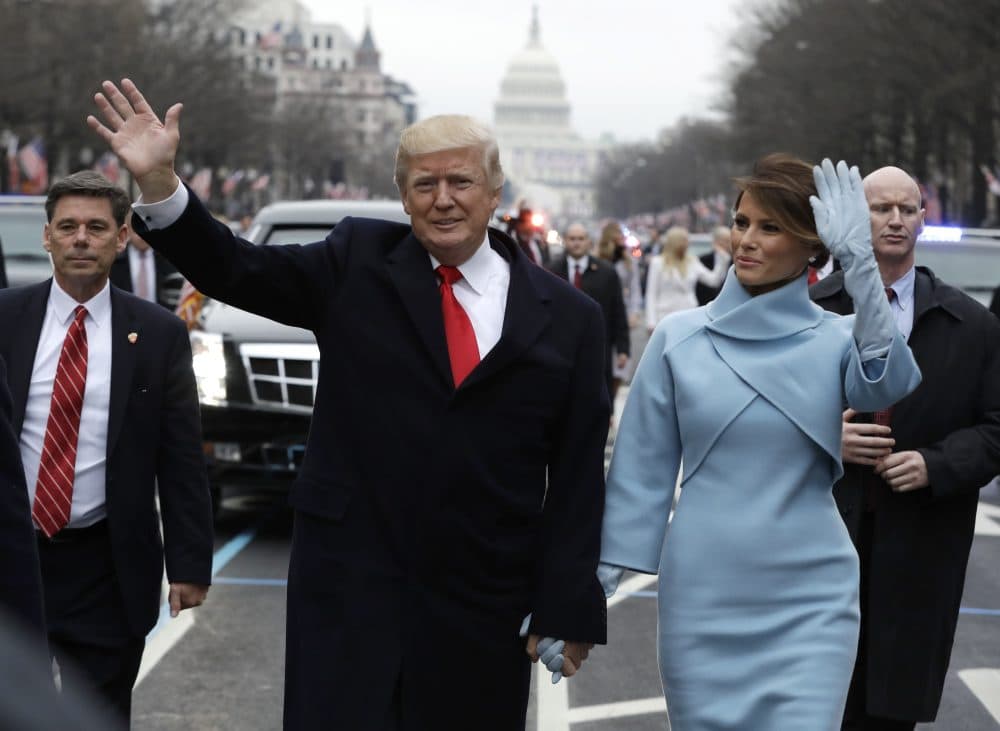 President Donald Trump waves as he walks with first lady Melania Trump during the inauguration parade on Pennsylvania Avenue in Washington, Friday, Jan. 20, 2016. (Evan Vucci/AP)