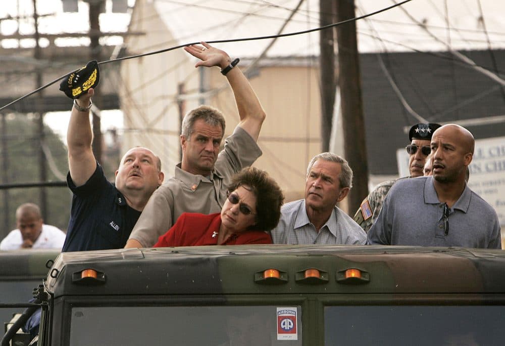 In this Sept. 12, 2005 file photo, officials lift up a downed power line during a tour of Hurricane Katrina-ravaged New Orleans with, from third left, Lousiana Gov. Kathleen Blanco, President George W. Bush, Lt. Gen. Russell Honore and New Orleans Mayor Ray Nagin. (Susan Walsh/AP)