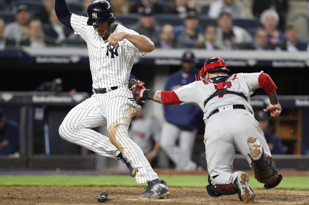 Boston Red Sox catcher Christian Vazquez (7) tags New York Yankees' Giancarlo Stanton out at the plate on a fielder's choice in the eighth inning of a baseball game in New York, Tuesday, May 8, 2018. (Kathy Willens/AP)