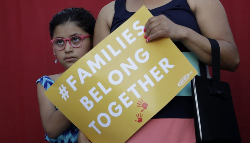 A girl stands with her mother during a Rally For Our Children event to protest a new "zero-tolerance" immigration policy that has led to the separation of families, Thursday, May 31, 2018, in San Antonio. (Eric Gay/AP)