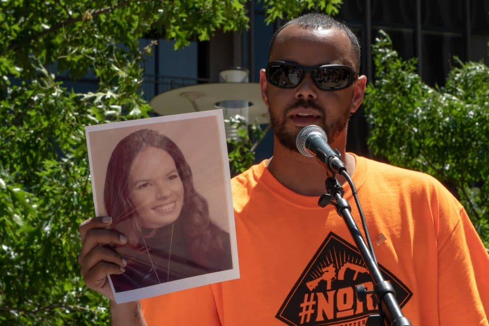 Khary Penebaker holds a photograph of his mother, Joyce, at a protest of the NRA convention in Dallas, Texas, on May 5, 2018. (Courtesy of NoRA)