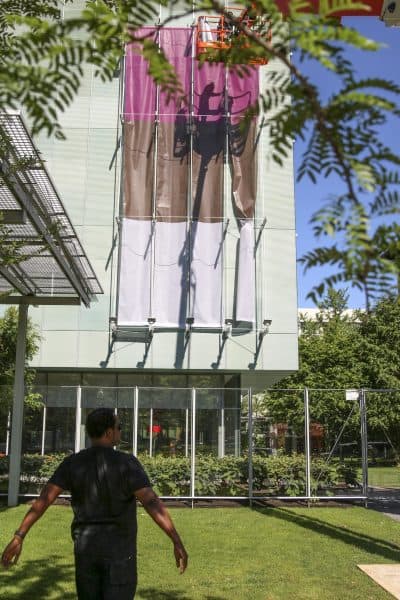 Artist Steve Locke watches the installation of his piece, &quot;Three Deliberate Grays for Freddie.&quot; (Courtesy Isabella Stewart Gardner Museum)