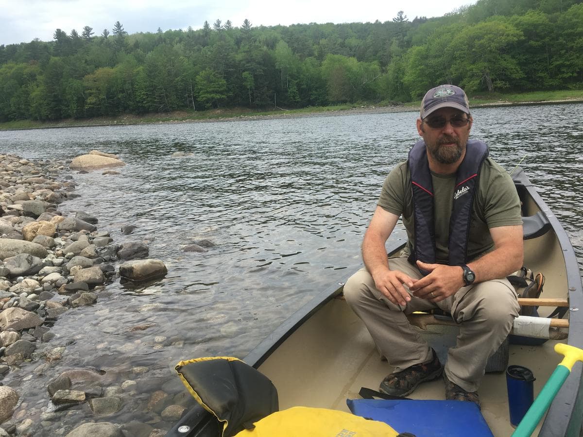 Greg Caruso is a ferryman for the Appalachian Trail. In season, he takes through-hikers across the Kennebec River, a few miles downstream from where CMP wants to build a major transmission line. He opposes the plan -- even with CMP’s offer to donate land and money in compensation. (Fred Bever/Maine Public)