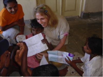 Dr. Judith Kuriansky with children drawing pictures post-tsunami in Sri Lanka. (Courtesy Judith Kuriansky)