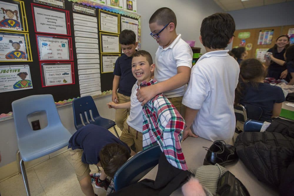 In Revere, English-learning students try on clothes as part of a vocabulary exercise. (Jesse Costa/WBUR)