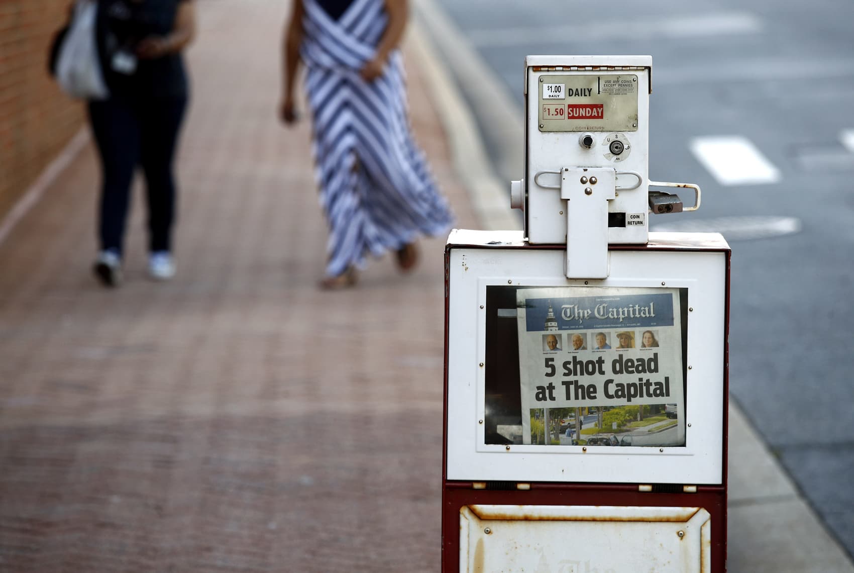A Capital Gazette newspaper rack displays the day's front page, Friday, June 29, 2018, in Annapolis, Md. A man armed with smoke grenades and a shotgun attacked journalists in the newspaper's building Thursday, killing several people before police quickly stormed the building and arrested him, police and witnesses said. (Patrick Semansky/AP)