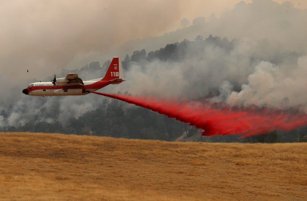 A firefighting air tanker drops fire retardant on a hillside ahead of the County fire on July 2, 2018 in Esparto, Calif. (Justin Sullivan/Getty Images)