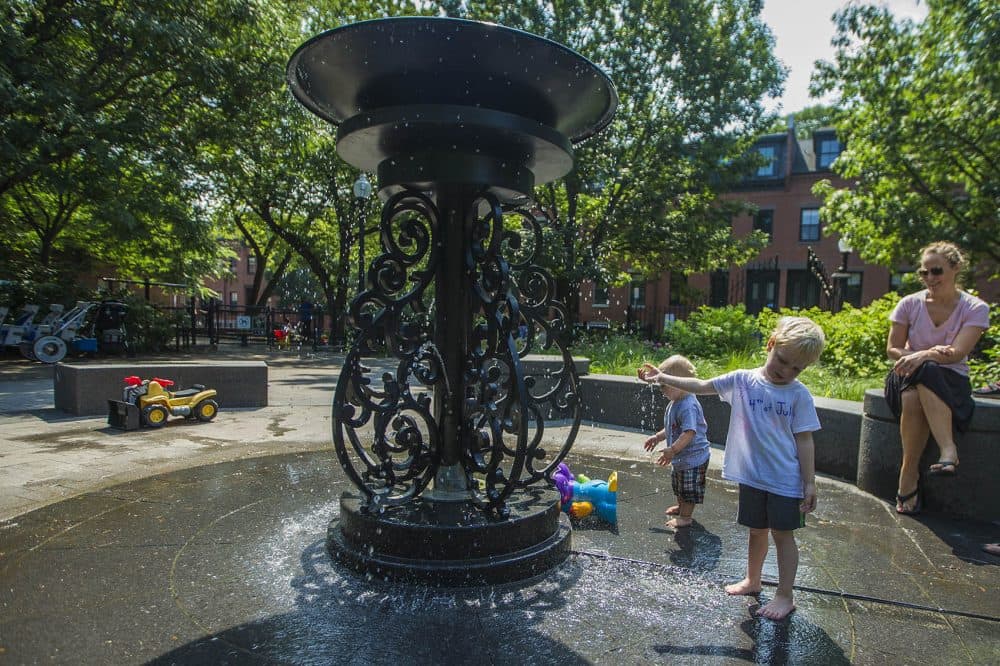 Four-year-old Alexander Hady tests the water coming from the fountain at Ringgold Park in the South End. (Jesse Costa/WBUR)