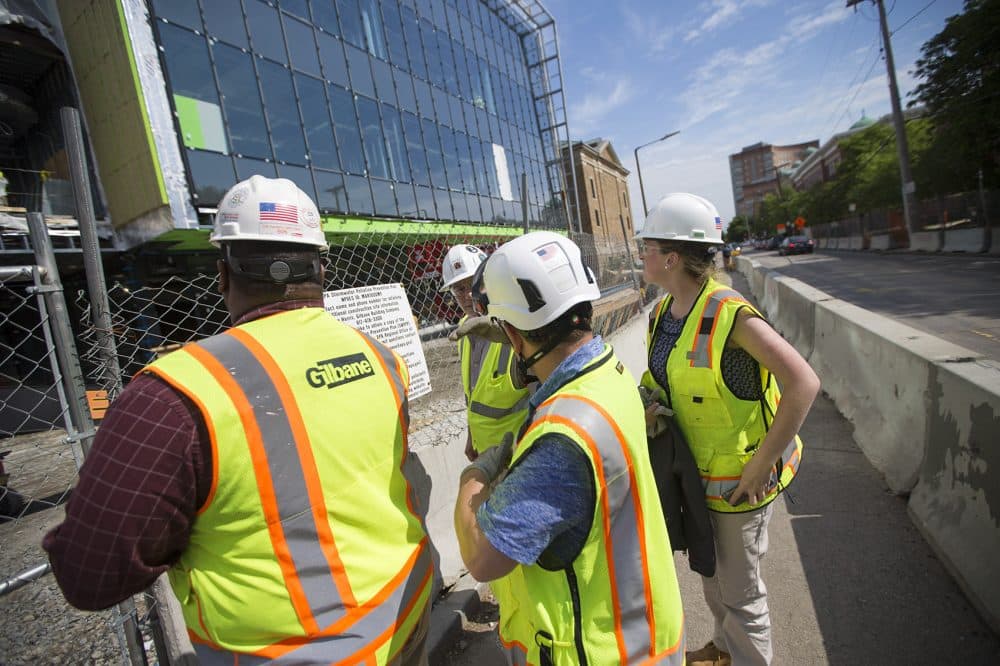 The tour group stops in front of the construction site on Parker Street of what will become Wentworth's new building for engineering, innovations and sciences.(Jesse Costa/WBUR)