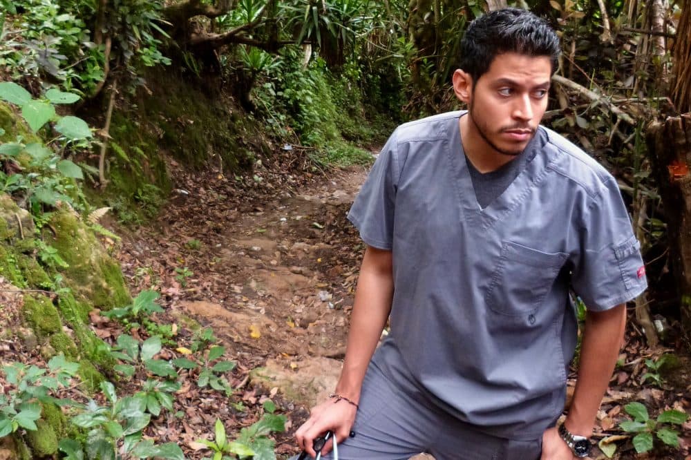 Dr. Marco Corea hikes to the home of Ludis and Gledia Rodriguez. Corea diagnosed Gledia with autism and anxiety. (Karyn Miller-Medzon/Here &amp; Now)