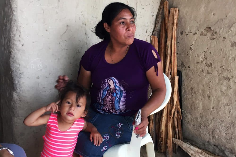 Ludis Marleny Rodriguez sits with her youngest daughter. (Karyn Miller-Medzon/Here &amp; Now)
