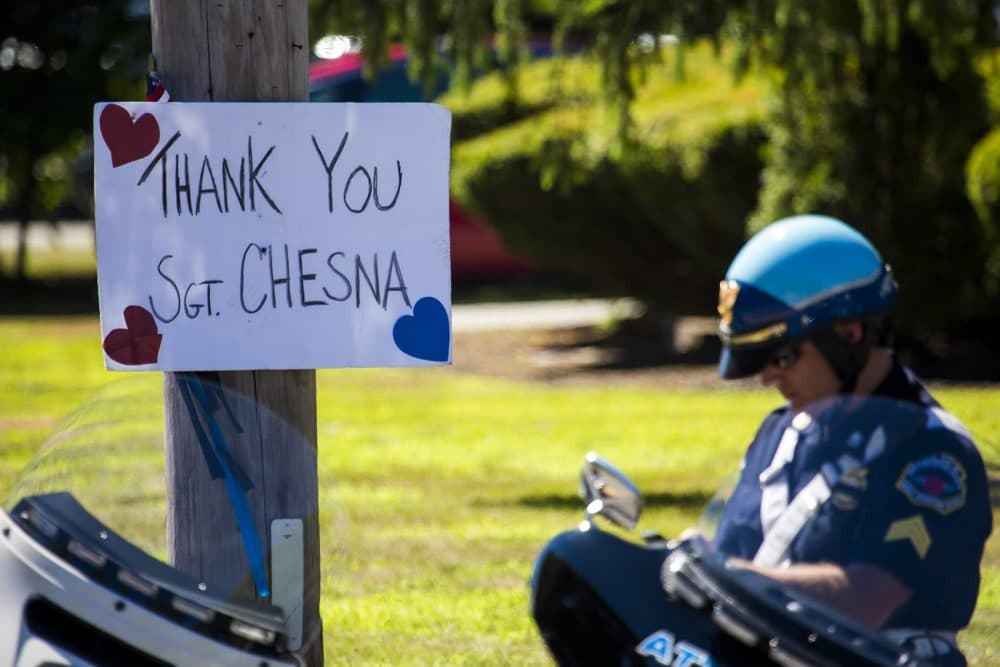 A sign reading &quot;Thank you Sgt. Chesna&quot; hung on a utility pole outside of Saint Mary of the Sacred Heart Church in Hanover. (Jesse Costa/WBUR)
