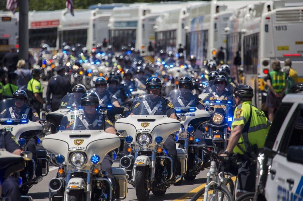 Hundreds of motorcycle policeman ride down lead the funeral procession. (Jesse Costa/WBUR)