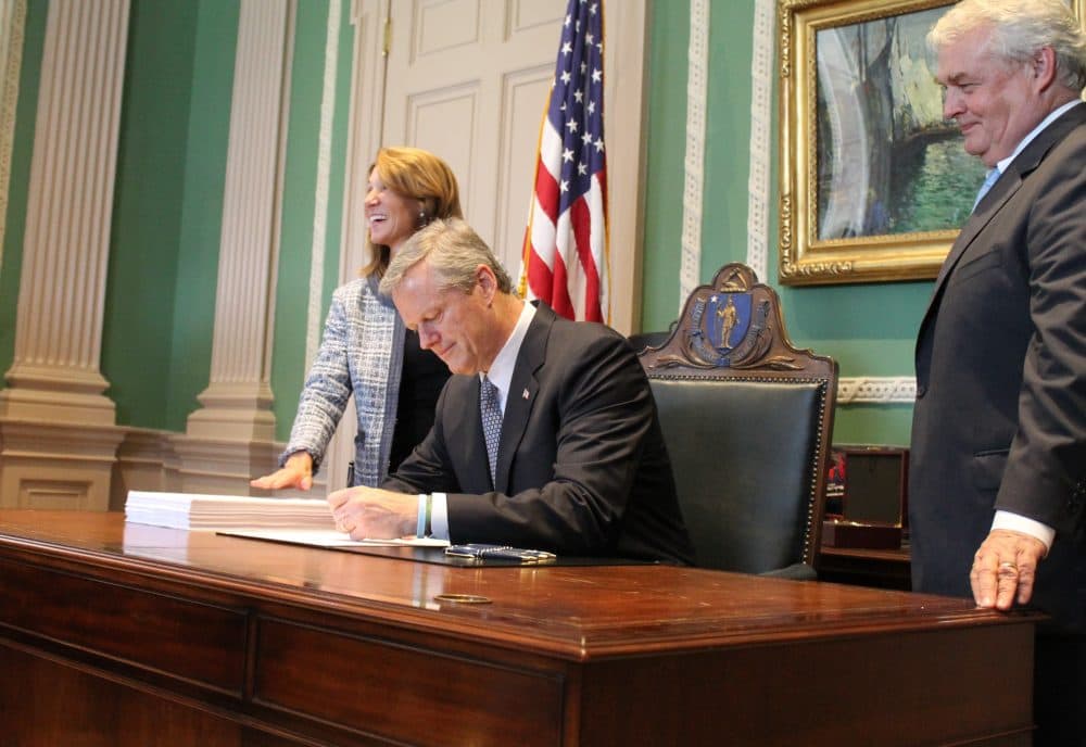 Gov. Charlie Baker signed the fiscal 2019 budget in his office alongside Lt. Gov. Karyn Polito and Administration and Finance Secretary Mike Heffernan in July 2018. (Sam Doran/State House News Service)