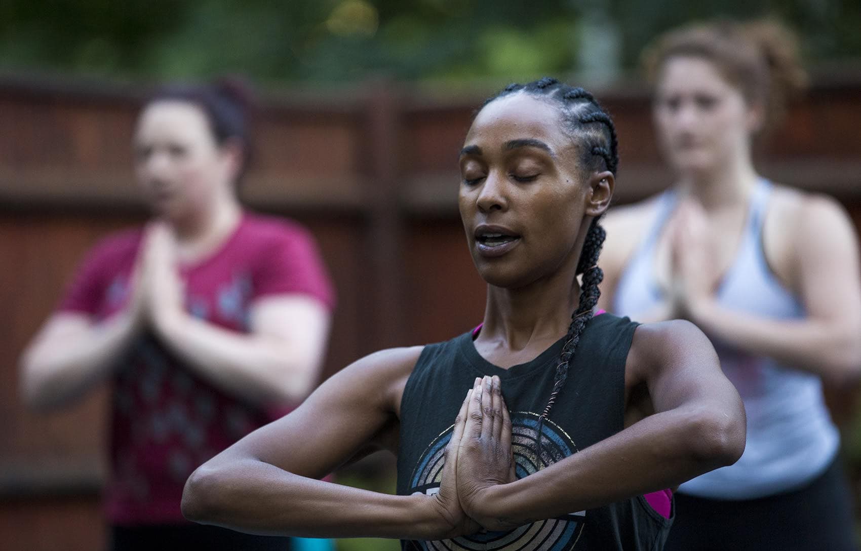 Kijana Rose directs her Beginners Ganja Yoga Flow students. (Jesse Costa/WBUR)