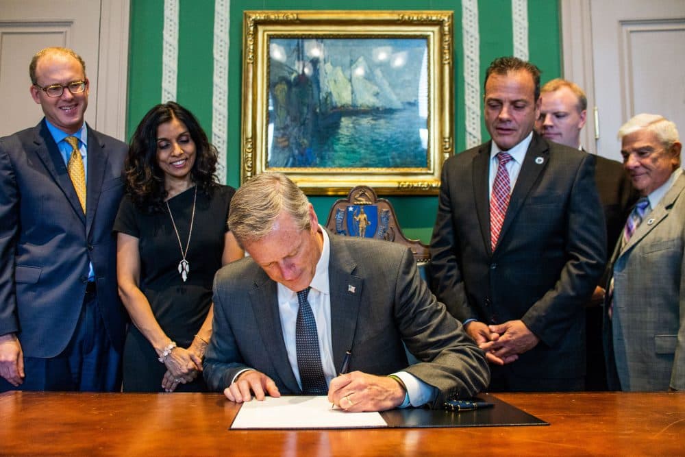 Gov. Charlie Baker signs into law a statewide measure that raises the legal age to purchase tobacco products from 18 to 21. (Courtesy Josephine Pettigrew/Office of the Governor via flickr)