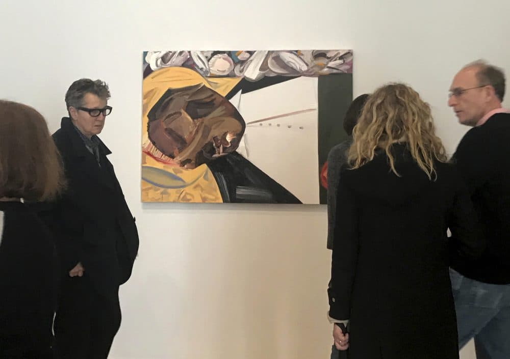 A group of museum-goers examine a painting entitled "Open Casket" by artist Dana Schutz at the Whitney Museum of American Art in New York, Thursday, March 23, 2017. The painting, made with the aid of historical photographs of Emmett Till as he lay in his casket, left some gravely displeased and triggered outcry. Till was a 14-year-old black teenager when he was killed by white men in 1955 for allegedly whistling at a white woman. (Alina Heineke/AP)