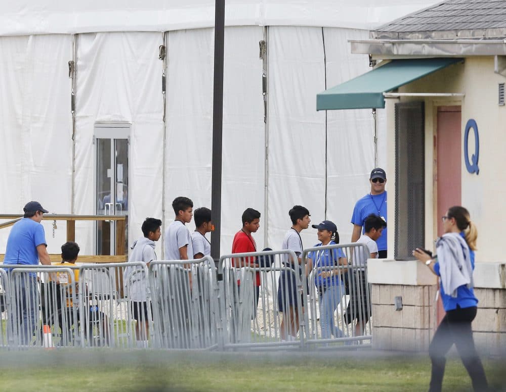 Immigrant children walk in a line outside the Homestead Temporary Shelter for Unaccompanied Children a former Job Corps site that now houses them, on Wednesday, June 20, 2018, in Homestead, Fla. (Brynn Anderson/AP)