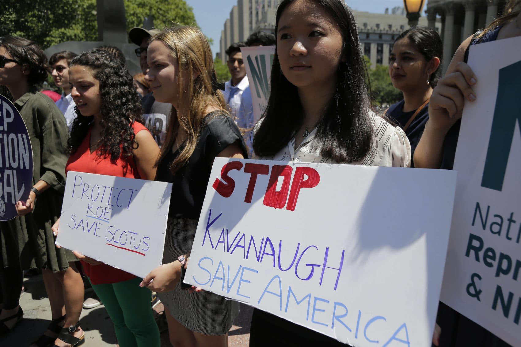 People hold signs at a rally opposing supreme court nominee Brett Kavanaugh in New York, Tuesday, July 10, 2018. (Seth Wenig/AP)