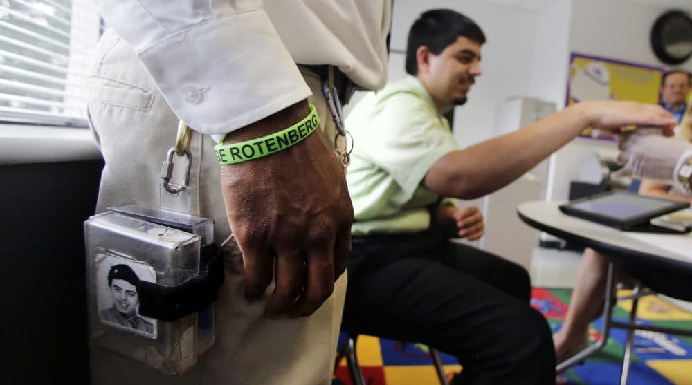 A therapist wears the remote shocking device on his belt as he monitors a student who is autistic at the Judge Rotenberg Educational Center in Canton, Massachusetts. Many students at the school, who were born with autism and development disorders, wear shocking devices to control violent outbreaks. (Charles Krupa/AP)
