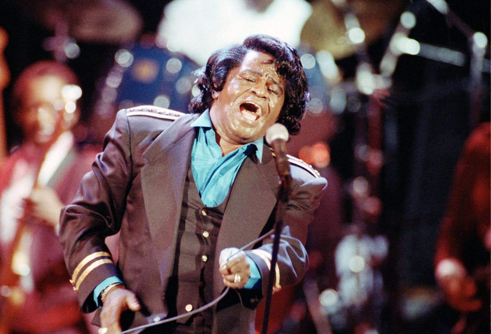 James Brown sings "Living in America" during a concert at the Wiltern Theater in Los Angeles on June 10, 1991. (Kevork Djansezian/AP)