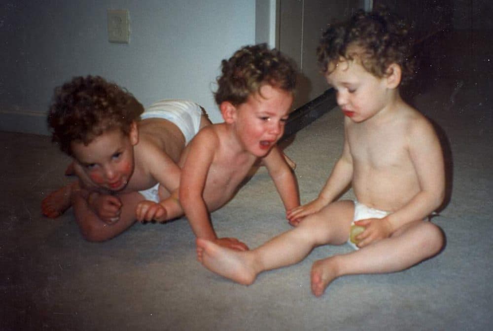 My brothers and I wrestling on the floor. Ian is on the left, I'm in the middle and Morgan is on the right. (Courtesy Kaplan family)