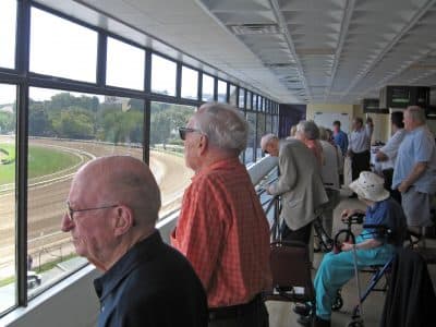 Seniors from the North Hill retirement community watch the racetrack at Suffolk Downs in East Boston. (Bill Littlefield/OAG)