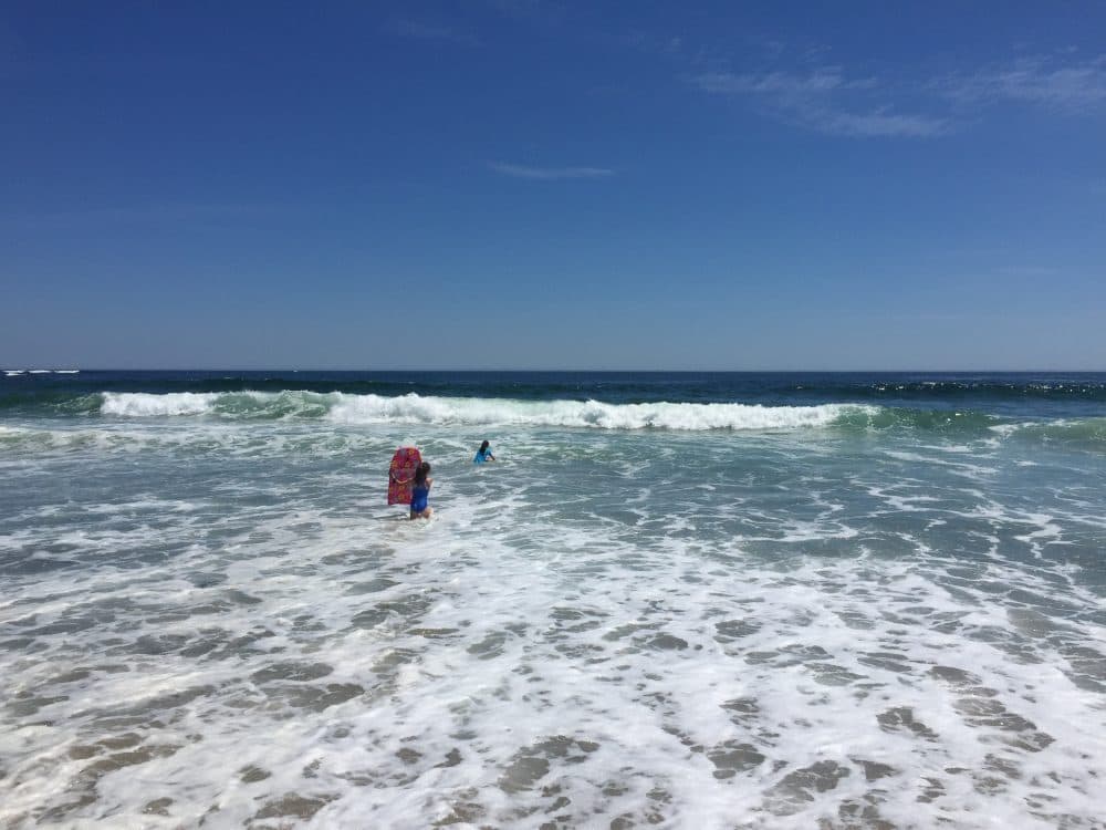 The author's daughters, aged 8 and 9, play in the water at Fortune's Rocks beach in Biddeford, ME in June 2018. (Courtesy)