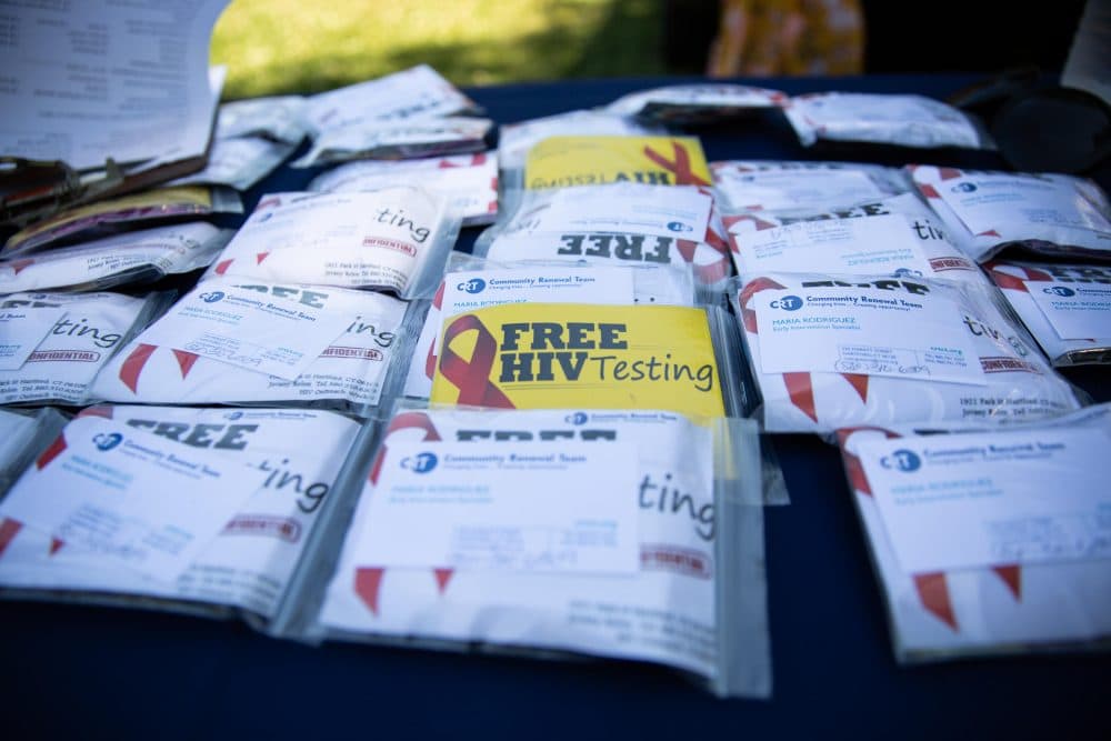 An HIV prevention crew at Community Renewal Team distributes baggies of information during an outing at Hartford's Barnard Park. The team was promoting PrEP, a preventative drug, and offering free, rapid HIV screenings in the backseat of a CRT employee's Nissan Rogue. (Ryan Caron King/NENC)