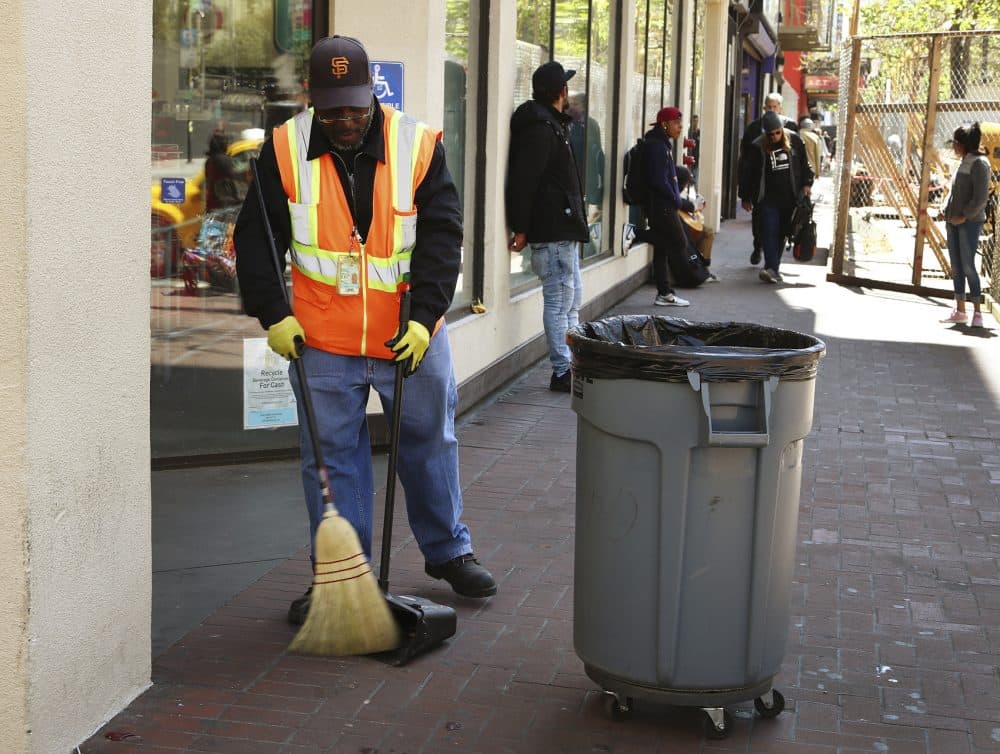 In this photo taken on Thursday, April 26, 2018, a city sanitation worker sweeps Market Street in San Francisco. San Francisco may have hit peak saturation with the stinky urine, used syringes and trash littering its filthy streets, and city leaders are paying attention. (Ben Margot/AP)