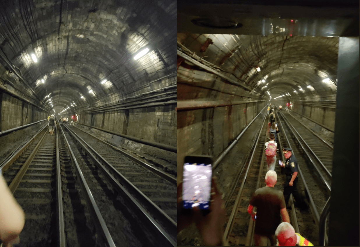 Blue Line passengers evacuate their train and walk through the tunnels. (Courtesy Ryan Mahan/Twitter)