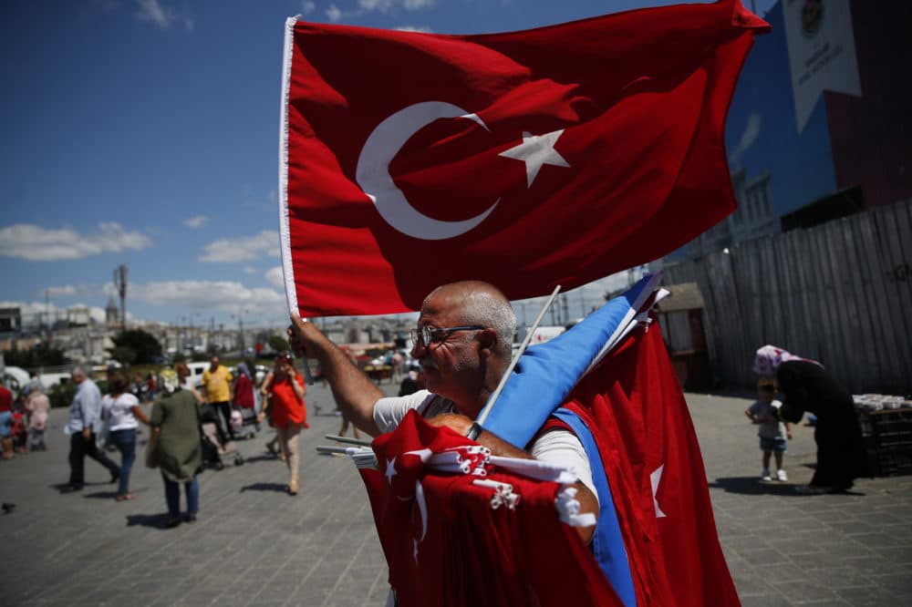 A vendor offers Turkish flags for sale at a market in Istanbul, Monday, Aug. 13, 2018. Turkey's central bank announced a series of measures on Monday to free up cash for banks as the country grapples with a currency crisis sparked by concerns over President Recep Tayyip Erdogan's economic policies and a trade and diplomatic dispute with the United States. (Lefteris Pitarakis/AP)