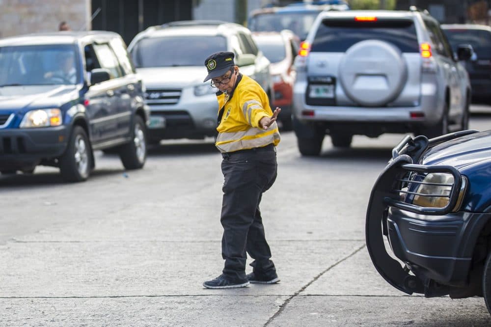 A traffic police officer gives an annoyed look while stopping an impatient driver at the intersection of Av Ramón Ernesto Cruz and Calle República del Ecuador in Tegucigalpa during rush-hour traffic. (Jesse Costa/WBUR)