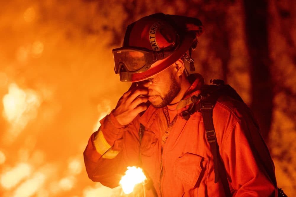 An inmate firefighter pauses during a firing operation as the Carr Fire burns in Redding, Calif., on July 27, 2018. (Josh Edelson/AFP/Getty Images)