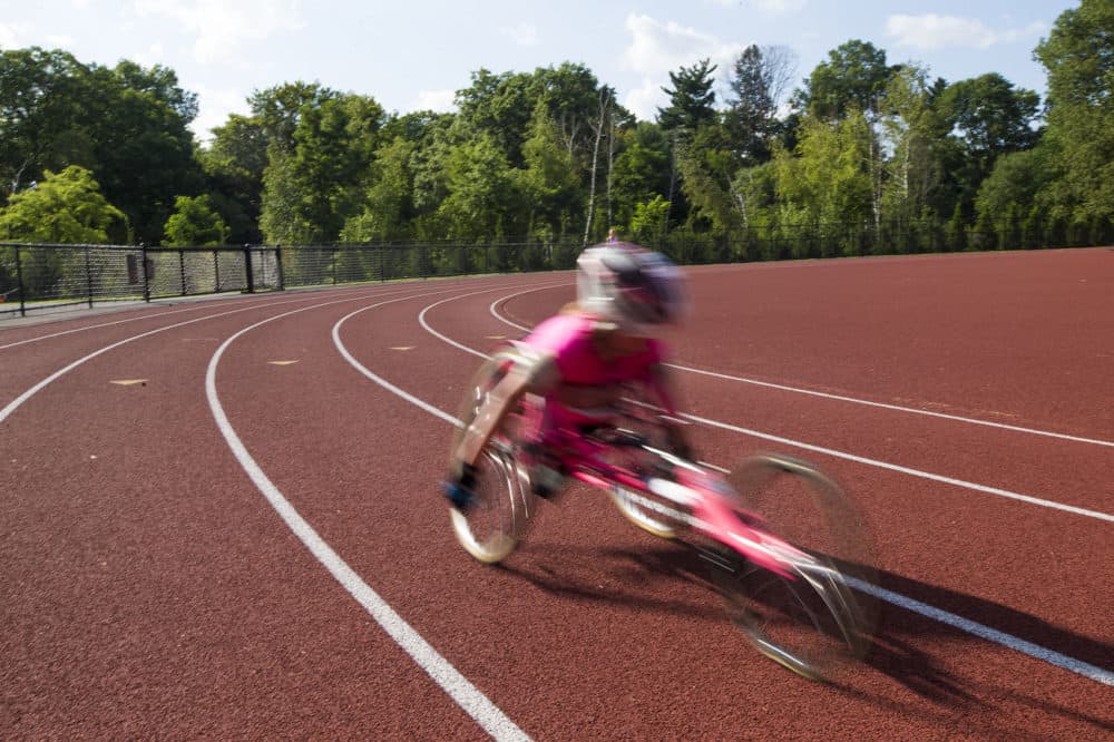 Maddie Wilson speeds around the track at Wellesley High School. (Jesse Costa/WBUR)