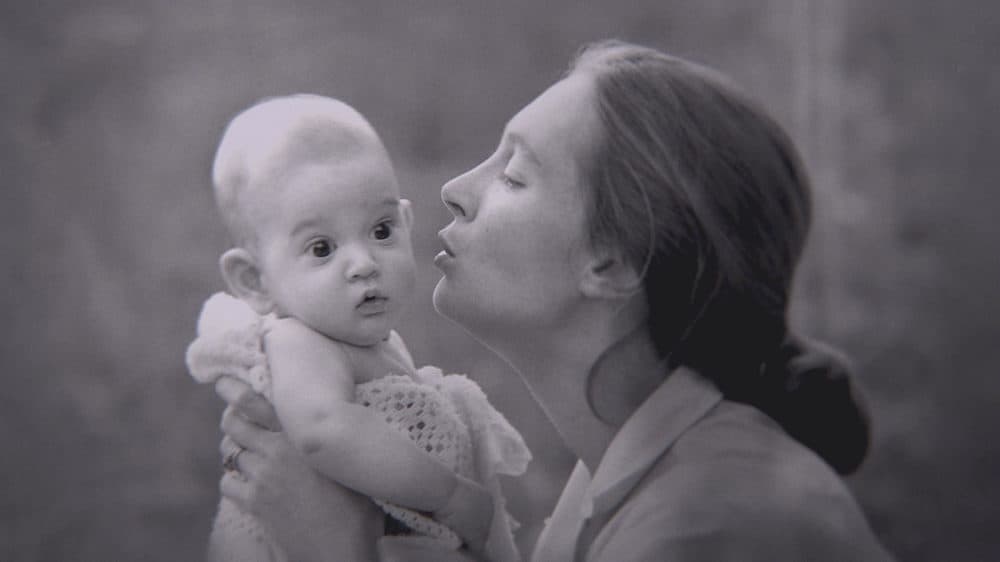 Gombe, Tanzania: Jane Goodall kisses her son Grub. (Jane Goodall Institute/Hugo van Lawick)