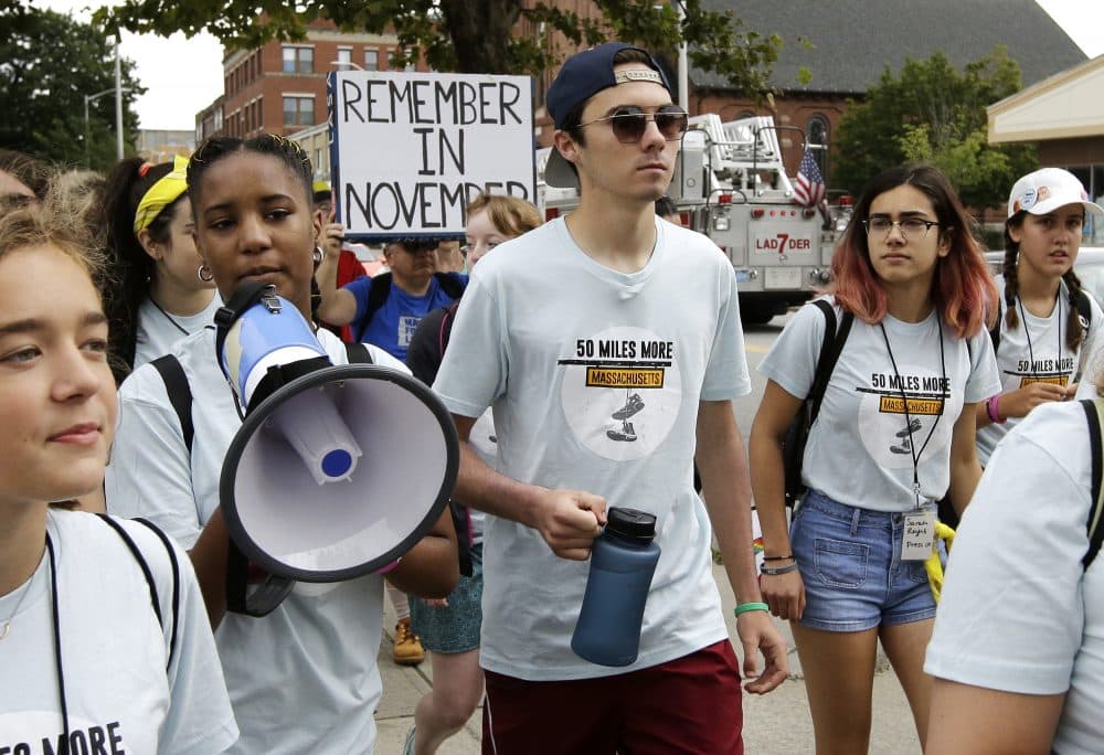 David Hogg, center, a survivor of the school shooting at Marjory Stoneman Douglas High School, in Parkland, Fla., walks in a planned 50-mile march in Worcester, Mass. (Steven Senne/AP)