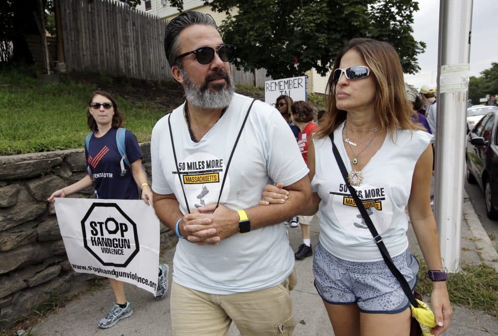 Manuel Oliver, center, and his wife Patricia, right, parents of slain Marjory Stoneman Douglas high school student Joaquin Oliver, walk in Worcester. (Steven Senne/AP)