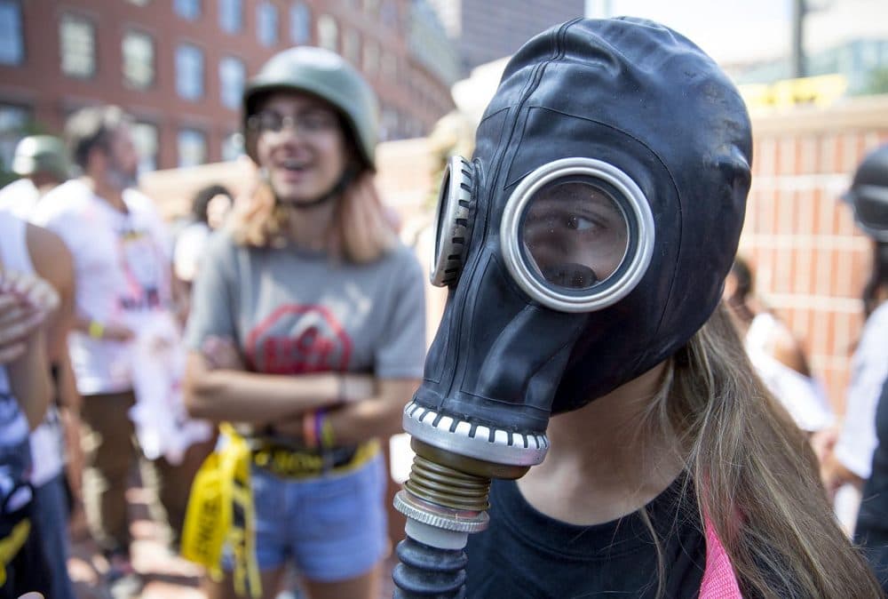 A student models a gas mask at the fashion show in City Hall Plaza. (Robin Lubbock/WBUR)