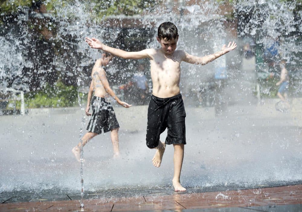 Children cool off in the Rings Fountain on the Rose Kennedy Greenway. (Robin Lubbock/WBUR)