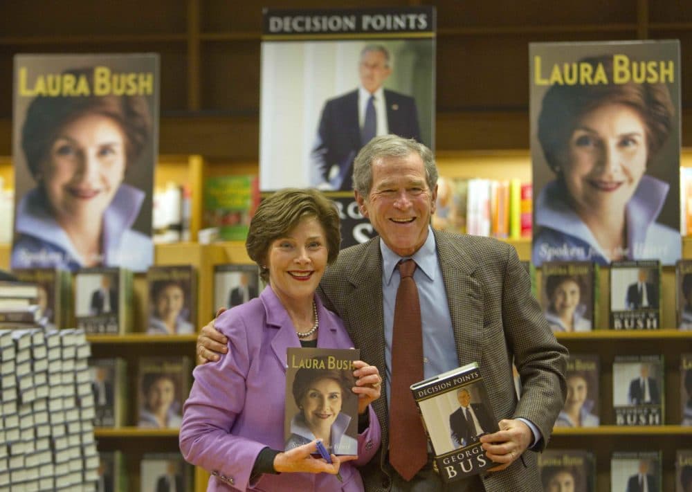 Former President George W. Bush, right, and his wife Laura appear together to sign their respective books, 'Decision Points' by him, ,and "Spoken From the Heart'" by her, Thursday, Dec. 16, 2010, in Atlanta. (David Goldman/AP)