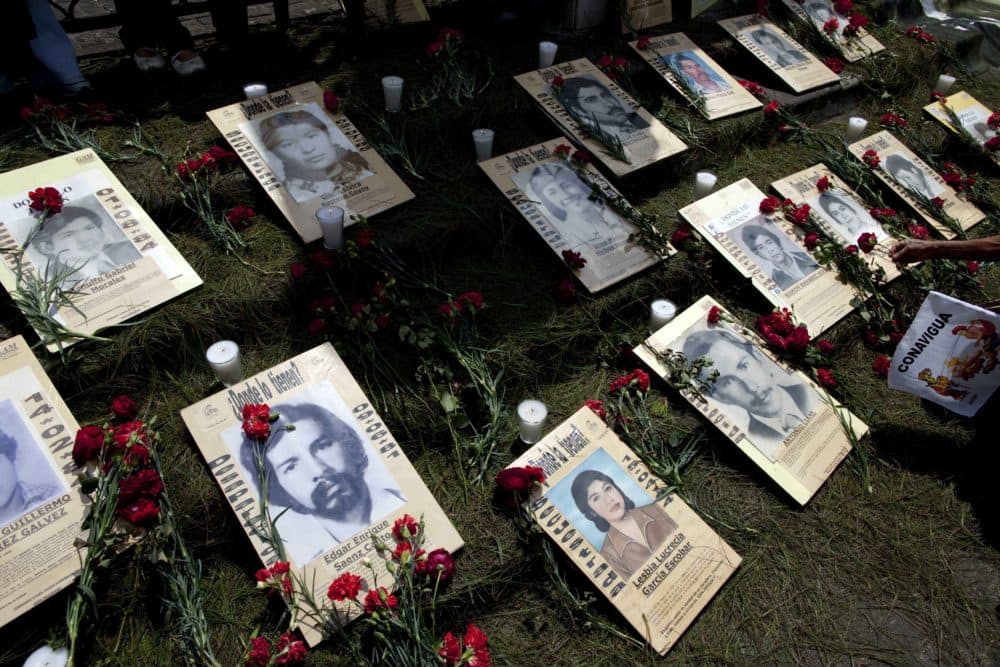Portraits of people who were allegedly disappeared by the Guatemalan army lay in front of the cathedral during a protest by human rights activists in Guatemala City on Feb. 24, 2011. (Rodrigo Abd/AP)