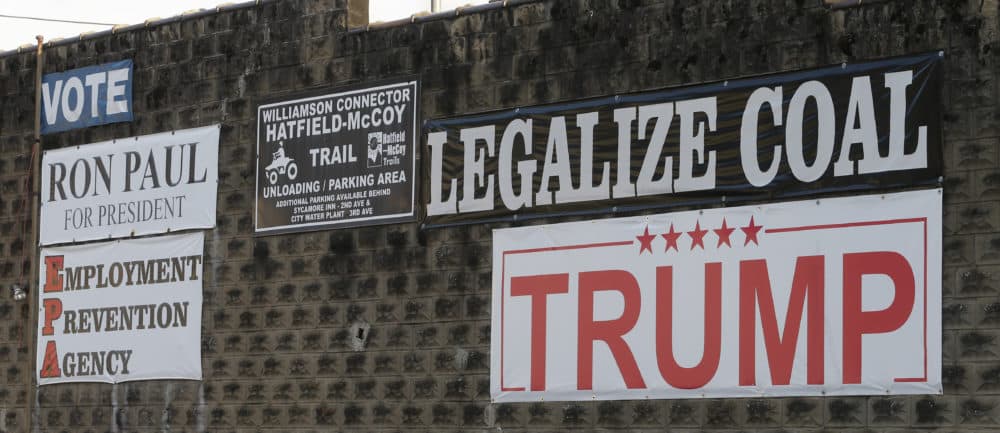 Political signs are posted on the wall of a building in Williamson , W.Va., Friday, Nov. 11, 2016. The hard-eyed view along the Tug Fork River in coal country is that Donald Trump has to prove he'll help Appalachian mining like he promised. (Steve Helber/AP)