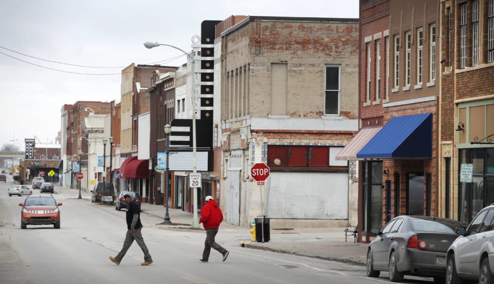 Local residents walk across Main Street, Friday, Jan. 27, 2017, in Ottumwa, Iowa. Far from the cacophony enveloping Washington in President Donald Trump's first week in office, the Iowa voters who helped him capture the state and the presidency last November give the president high marks for reversing eight years of Democrat Barack Obama's policies. (Charlie Neibergall/AP)