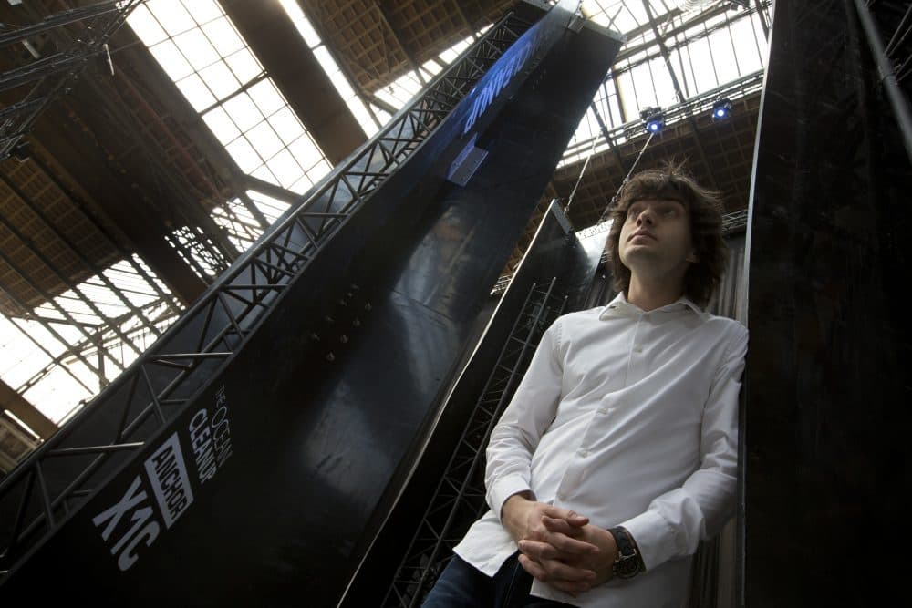 Dutch entrepreneur Boyan Slat, who founded The Ocean Cleanup project, poses for a portrait next to the anchors of his plastic collecting system, suspended from the roof of a building in Utrecht, Netherlands, in 2017. (Peter Dejong/AP)