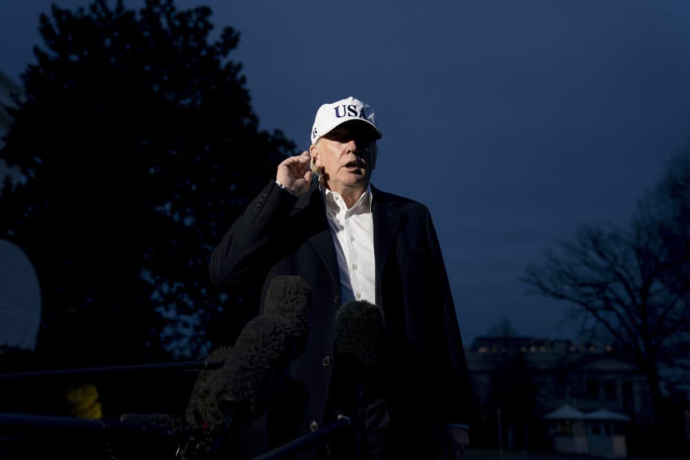 President Donald Trump tries to a hear a question from a member of the media on the South Lawn at the White House in Washington, Sunday, Dec. 17, 2017. (Andrew Harnik/AP)
