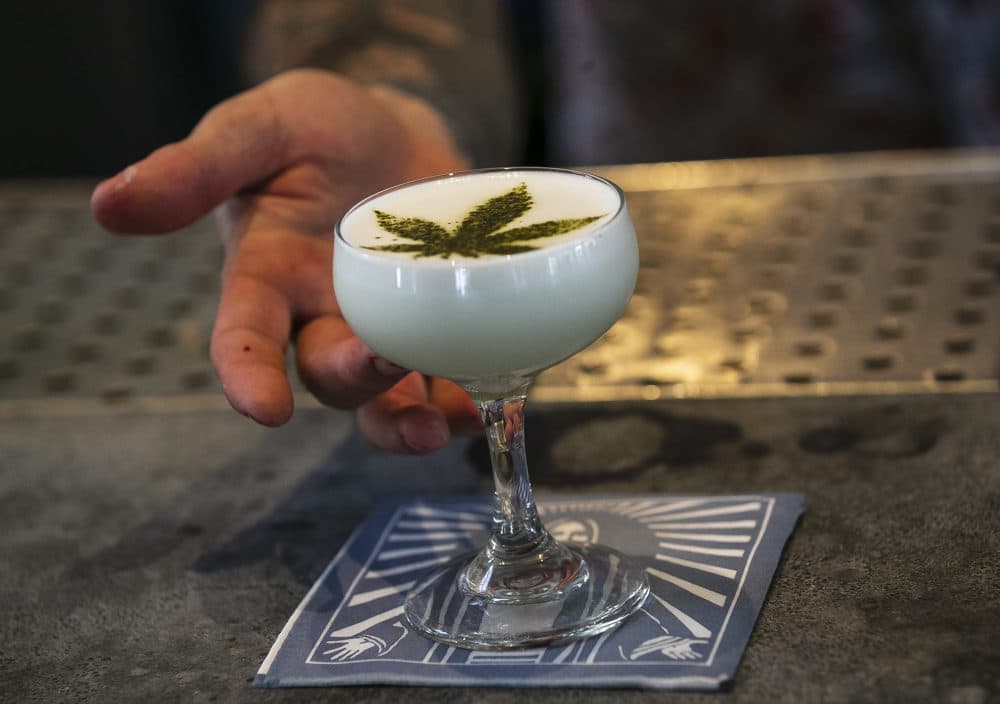 Beverage director Maxwell Reis serves a drink containing Cannabidiol CBD extract with a marijuana leaf motif at the Gracias Madre restaurant in West Hollywood, Calif. (Damian Dovarganes/AP)