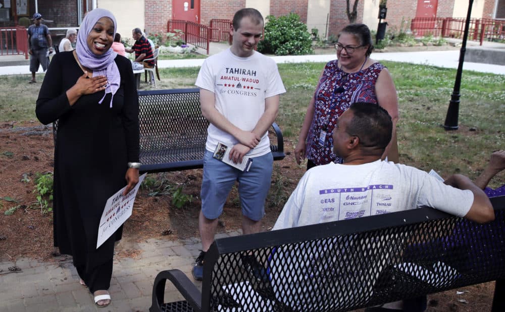 Tahirah Amatul-Wadud, left, who is challenging incumbent U.S. Rep. Richard Neal, greets residents of an apartment complex while campaigning June 18 in Springfield. (Charles Krupa/AP)